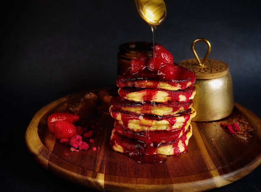 A bowl of pancake cereal topped with berries and maple syrup, served as a kid-friendly breakfast option